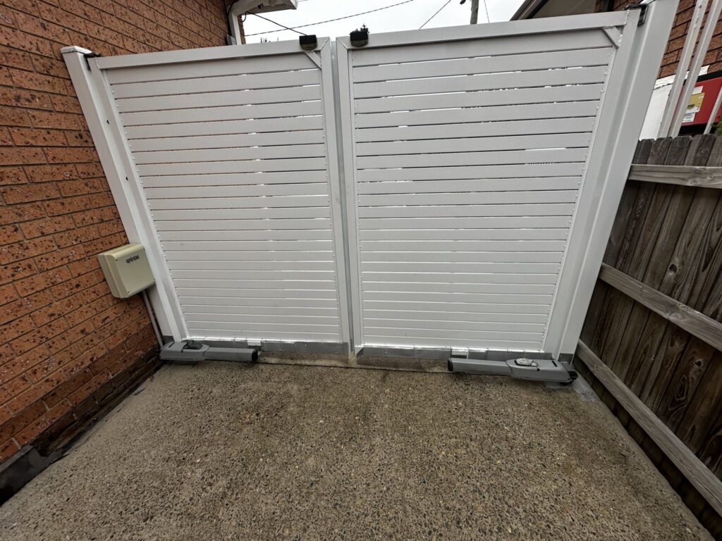 White slatted double swing gate with automatic gate motors