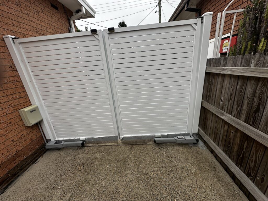 White slatted automatic gate on a residential driveway in Sydney