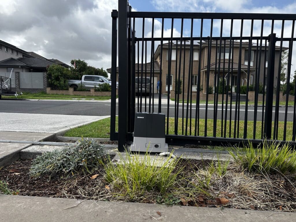 Black automatic sliding gate with gate motor at a Sydney home